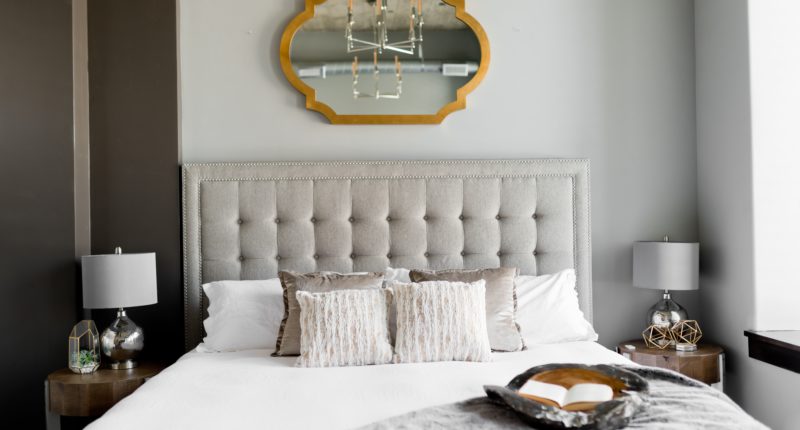 tufted white bed near window